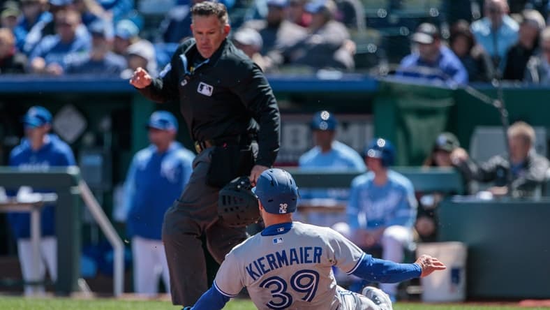 Apr 6, 2023; Kansas City, Missouri, USA; Toronto Blue Jays center fielder Kevin Kiermaier (39) slides into home plate during the second inning against the Kansas City Royals at Kauffman Stadium. Mandatory Credit: William Purnell-USA TODAY Sports