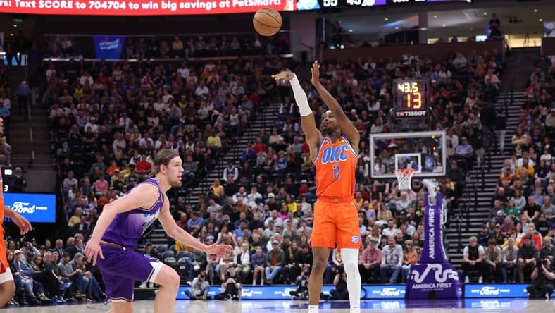 Apr 6, 2023; Salt Lake City, Utah, USA; Oklahoma City Thunder guard Shai Gilgeous-Alexander (2) shoots a three point shot over Utah Jazz forward Kelly Olynyk (41) in the second quarter at Vivint Arena. Mandatory Credit: Rob Gray-USA TODAY Sports