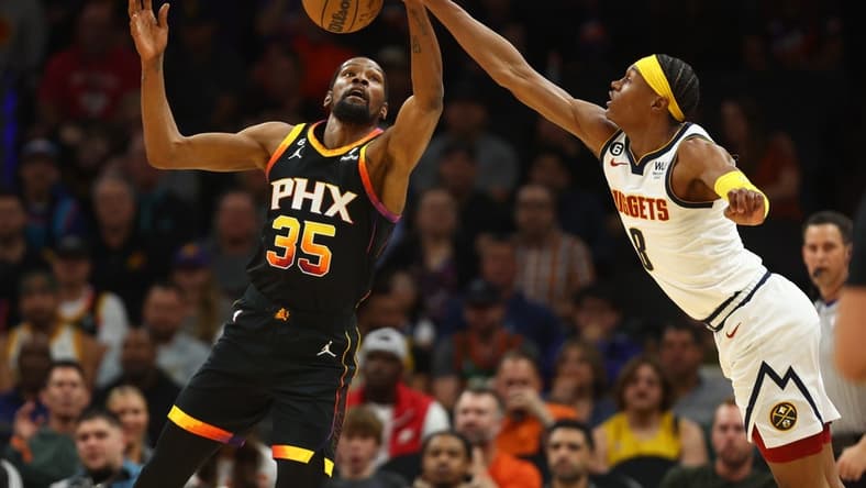 Apr 6, 2023; Phoenix, Arizona, USA; Phoenix Suns forward Kevin Durant (35) grabs a loose ball against Denver Nuggets forward Peyton Watson (8) in the first half at Footprint Center. Mandatory Credit: Mark J. Rebilas-USA TODAY Sports