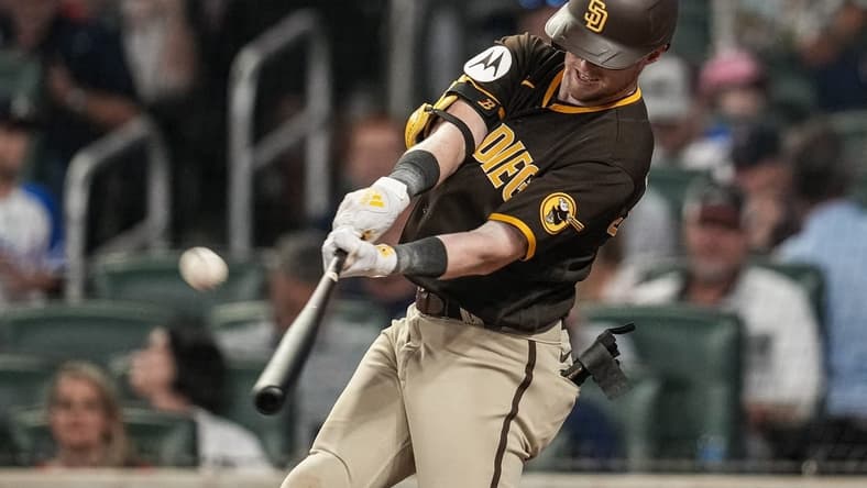 Apr 6, 2023; Cumberland, Georgia, USA; San Diego Padres first baseman Jake Cronenworth (9) hits a home run against the Atlanta Braves during the sixth inning at Truist Park. Mandatory Credit: Dale Zanine-USA TODAY Sports