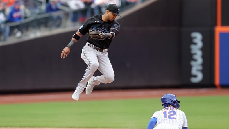 Apr 7, 2023; New York City, New York, USA; New York Mets shortstop Francisco Lindor (12) steals second base as the ball goes by Miami Marlins second baseman Luis Arraez (3) allowing Lindor to advance to third during the sixth inning at Citi Field. Mandatory Credit: Brad Penner-USA TODAY Sports