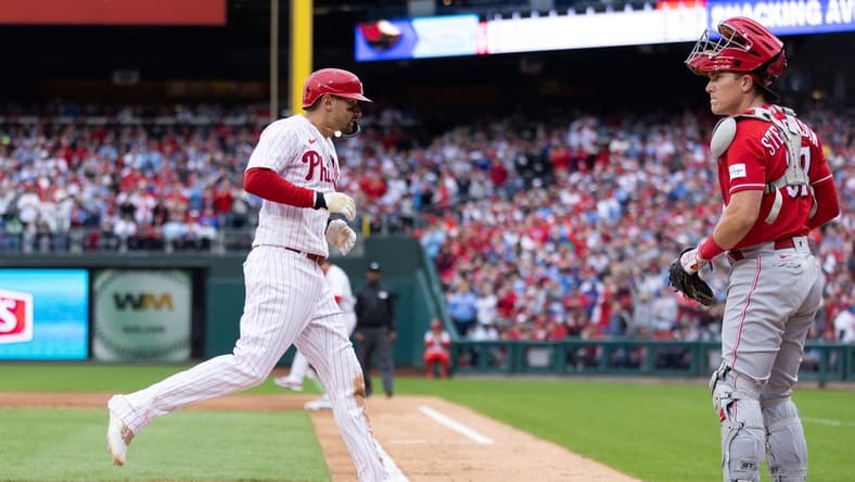 Apr 7, 2023; Philadelphia, Pennsylvania, USA; Philadelphia Phillies right fielder Nick Castellanos (8) crosses home plate in front of Cincinnati Reds catcher Tyler Stephenson (37) on a bases loaded walk during the second inning at Citizens Bank Park. Mandatory Credit: Bill Streicher-USA TODAY Sports