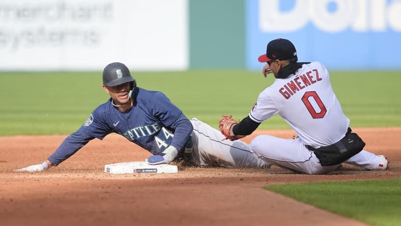 Apr 7, 2023; Cleveland, Ohio, USA; Seattle Mariners center fielder Julio Rodriguez (44) steals second as Cleveland Guardians second baseman Andres Gimenez (0) is late with the tag during the third inning at Progressive Field. Mandatory Credit: Ken Blaze-USA TODAY Sports