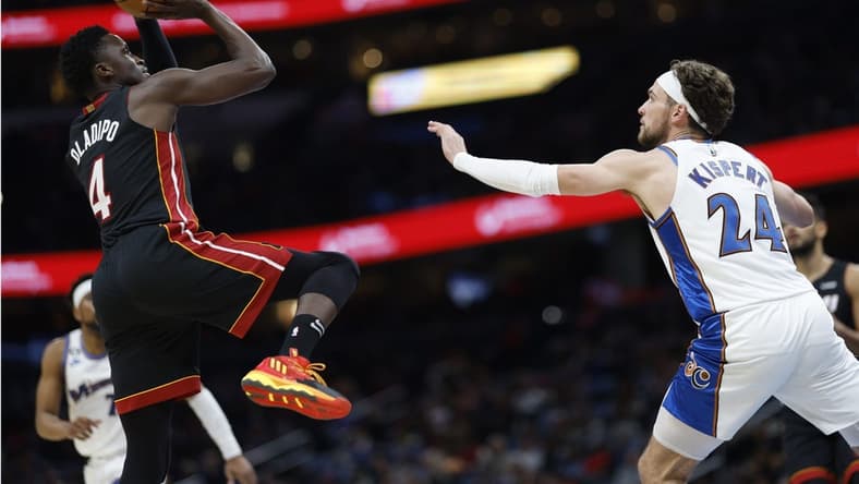 Apr 7, 2023; Washington, District of Columbia, USA; Miami Heat guard Victor Oladipo (4) shoots the ball over Washington Wizards forward Corey Kispert (24) in the second quarterat Capital One Arena. Mandatory Credit: Geoff Burke-USA TODAY Sports