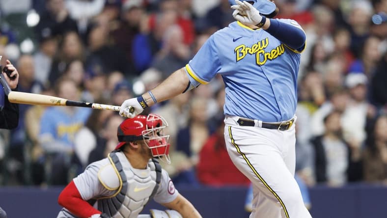 Apr 7, 2023; Milwaukee, Wisconsin, USA;  Milwaukee Brewers first baseman Rowdy Tellez (11) drives in a run with a sacrifice fly ball during the third inning against the St. Louis Cardinals at American Family Field. Mandatory Credit: Jeff Hanisch-USA TODAY Sports