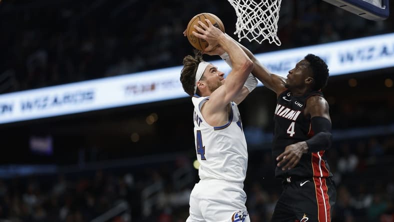 Apr 7, 2023; Washington, District of Columbia, USA; Washington Wizards forward Corey Kispert (24) is fouled while shooting the ball by Miami Heat guard Victor Oladipo (4) in the fourth quarter at Capital One Arena. Mandatory Credit: Geoff Burke-USA TODAY Sports