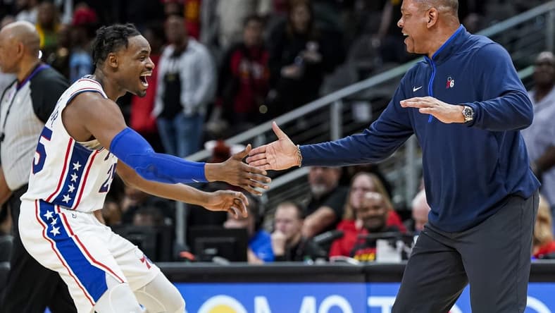 Apr 7, 2023; Atlanta, Georgia, USA; Philadelphia 76ers forward Danuel House Jr. (25) and head coach Glenn Rivers react during a timeout during the game against the Atlanta Hawks during overtime at State Farm Arena. Mandatory Credit: Dale Zanine-USA TODAY Sports