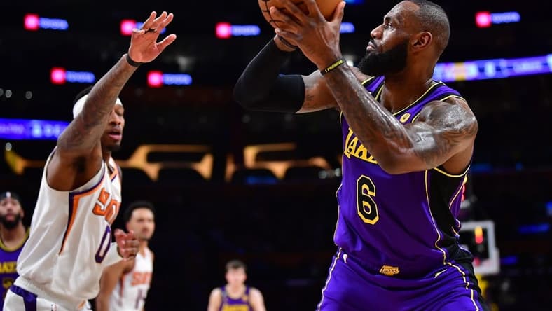 Apr 7, 2023; Los Angeles, California, USA; Los Angeles Lakers forward LeBron James (6) shoots against Phoenix Suns forward Torrey Craig (0) during the first half at Crypto.com Arena. Mandatory Credit: Gary A. Vasquez-USA TODAY Sports