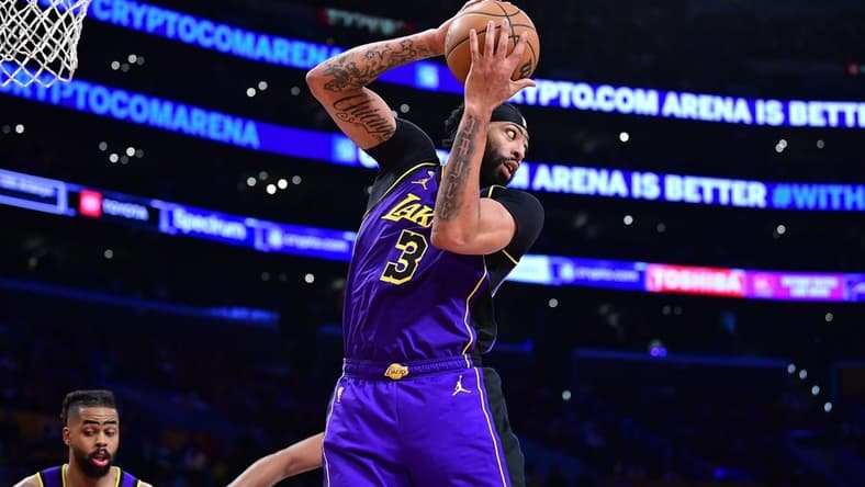 Apr 7, 2023; Los Angeles, California, USA; Los Angeles Lakers forward Anthony Davis (3) gets the rebound against the Phoenix Suns during the second half at Crypto.com Arena. Mandatory Credit: Gary A. Vasquez-USA TODAY Sports