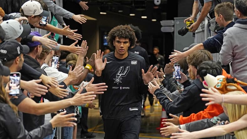 Apr 8, 2023; Austin, Texas, USA; San Antonio Spurs forward Dominick Barlow (26) greets fans on his way to the court before the game against the Minnesota Timberwolves at Moody Center. Mandatory Credit: Scott Wachter-USA TODAY Sports