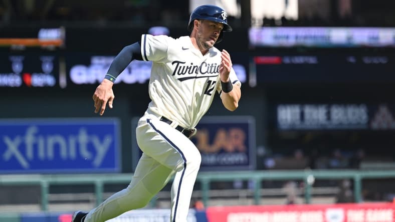 Apr 8, 2023; Minneapolis, Minnesota, USA; Minnesota Twins third baseman Kyle Farmer (12) scores on a single by catcher Christian Vazquez (not pictured) during the sixth inning against the Houston Astros at Target Field. Mandatory Credit: Jeffrey Becker-USA TODAY Sports