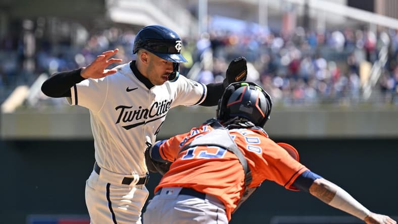 Apr 8, 2023; Minneapolis, Minnesota, USA; Minnesota Twins shortstop Carlos Correa (4) is tagged out at home by Houston Astros catcher Martin Maldonado (15) during the second inning at Target Field. Mandatory Credit: Jeffrey Becker-USA TODAY Sports