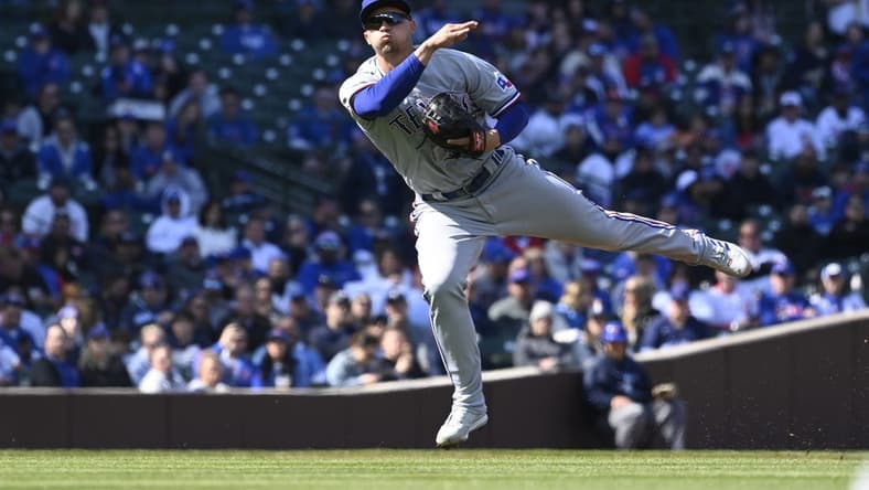 Apr 8, 2023; Chicago, Illinois, USA;  Texas Rangers shortstop Corey Seager (5) throws to first base on a single hit by Chicago Cubs shortstop Dansby Swanson (not pictured) during the first inning at Wrigley Field. Mandatory Credit: Matt Marton-USA TODAY Sports