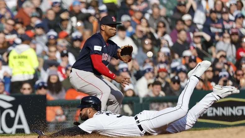 Apr 8, 2023; Detroit, Michigan, USA;  Detroit Tigers center fielder Riley Greene (31) dives in safe at third ahead of the throw to third baseman Rafael Devers (11) in the fourth inning at Comerica Park. Mandatory Credit: Rick Osentoski-USA TODAY Sports