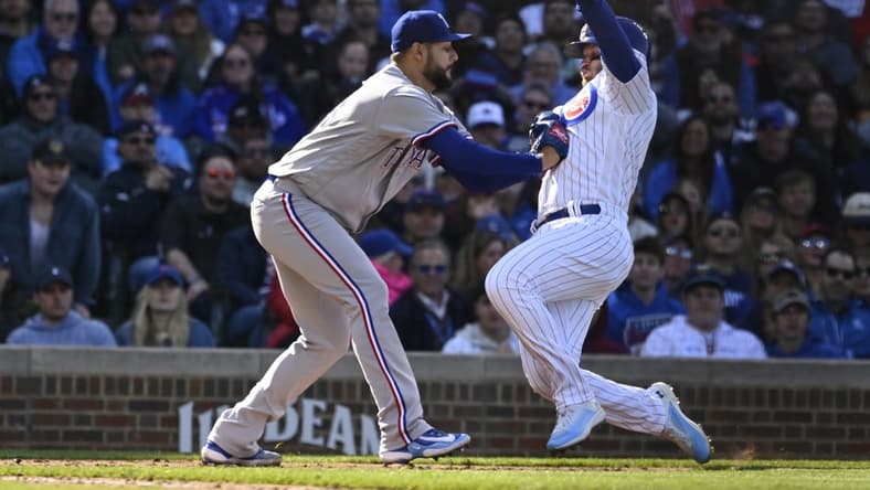 Apr 8, 2023; Chicago, Illinois, USA; Chicago Cubs left fielder Ian Happ (8) is forced out on an attempted steal at home plate by Texas Rangers starting pitcher Martin Perez (54) during the third inning at Wrigley Field. Mandatory Credit: Matt Marton-USA TODAY Sports