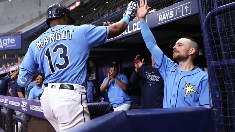 Apr 8, 2023; St. Petersburg, Florida, USA; Tampa Bay Rays right fielder Manuel Margot (13) is congratulated by second baseman Brandon Lowe (8) after hitting a home run against the Oakland Athletics during the sixth inning at Tropicana Field. Mandatory Credit: Kim Klement-USA TODAY Sports