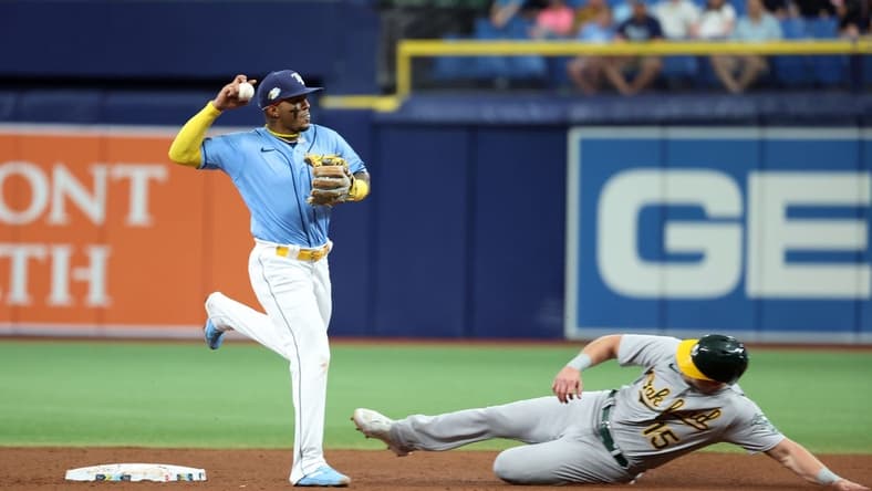 Apr 8, 2023; St. Petersburg, Florida, USA; Tampa Bay Rays shortstop Wander Franco (5) forces out Oakland Athletics left fielder Seth Brown (15) during the fifth inning at Tropicana Field. Mandatory Credit: Kim Klement-USA TODAY Sports