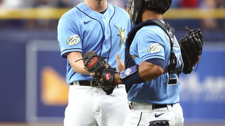 Apr 8, 2023; St. Petersburg, Florida, USA; Tampa Bay Rays relief pitcher Kevin Kelly (49) and catcher Francisco Mejia (21) celebrate after they defeated the Oakland Athletics at Tropicana Field. Mandatory Credit: Kim Klement-USA TODAY Sports