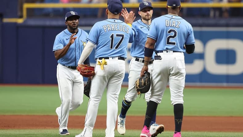Apr 8, 2023; St. Petersburg, Florida, USA; Tampa Bay Rays second baseman Brandon Lowe (8), first baseman Yandy Diaz (2),  third baseman Isaac Paredes (17) and second baseman Vidal Brujan (7) celebrate after defeating the Oakland Athletics at Tropicana Field. Mandatory Credit: Kim Klement-USA TODAY Sports
