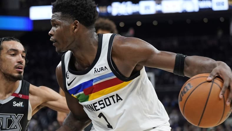 Apr 8, 2023; Austin, Texas, USA; Minnesota Timberwolves guard Anthony Edwards (1) drives to the basket while defended by San Antonio Spurs guard Tre Jones (33) during the second half at Moody Center. Mandatory Credit: Scott Wachter-USA TODAY Sports