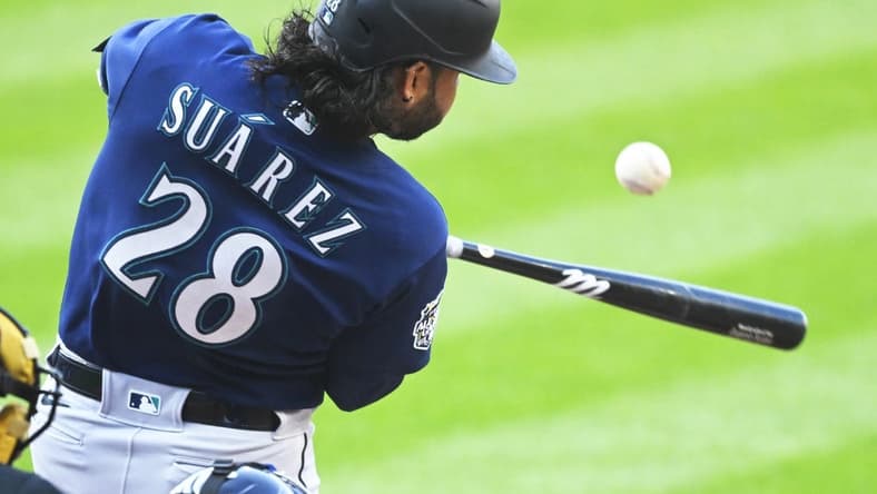 Apr 8, 2023; Cleveland, Ohio, USA; Seattle Mariners third baseman Eugenio Suarez (28) hits an RBI single in the first inning against the Cleveland Guardians at Progressive Field. Mandatory Credit: David Richard-USA TODAY Sports