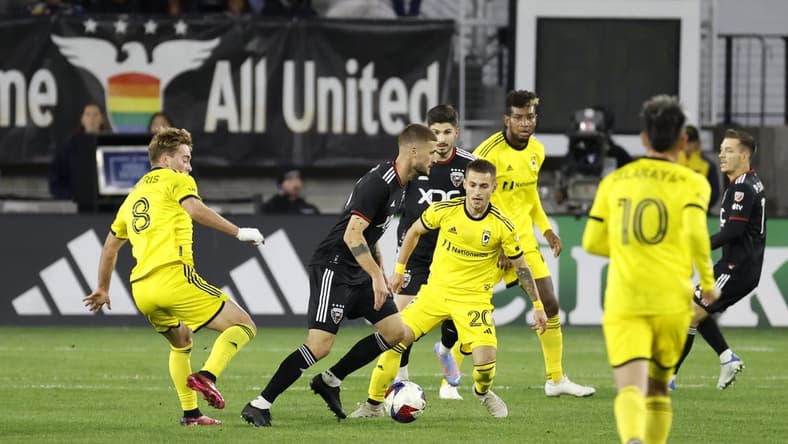 Apr 8, 2023; Washington, District of Columbia, USA; D.C. United midfielder Mateusz Klich (43) dribbles the ball against the Columbus Crew midfielder Aidan Morris (8) and Columbus Crew midfielder Alexandru Matan (20) at Audi Field. Mandatory Credit: Geoff Burke-USA TODAY Sports
