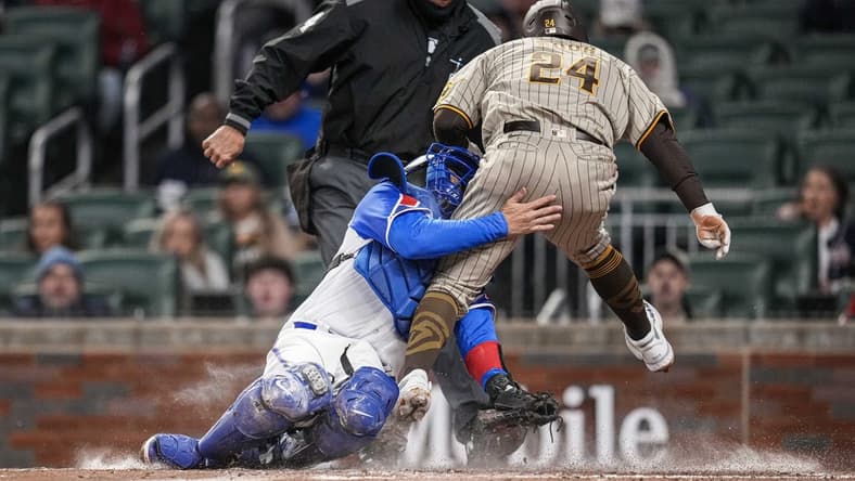 Apr 8, 2023; Cumberland, Georgia, USA; San Diego Padres right fielder Rougned Odor (24) is tagged out on a collision with Atlanta Braves catcher Travis d'Arnaud (16) during the fourth inning  at Truist Park. Mandatory Credit: Dale Zanine-USA TODAY Sports
