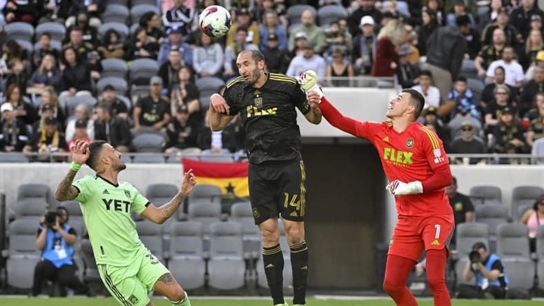 Apr 8, 2023; Los Angeles, California, USA;  Austin FC defender Amro Tarke (3) looks on as Los Angeles FC defender Giorgio Chiellini (14) deflects a shot on goal in front of Los Angeles FC goalkeeper Eldin Jakupovic (1) in the first half at BMO Stadium. Mandatory Credit: Jayne Kamin-Oncea-USA TODAY Sports