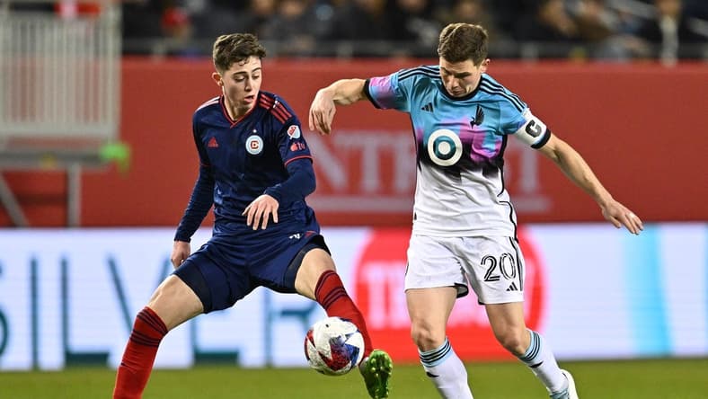 Apr 8, 2023; Chicago, Illinois, USA; Chicago Fire FC midfielder Brian Gutierrez (17) and Minnesota United midfielder Wil Trapp (20) battle for control of the ball in the first half at Soldier Field. Mandatory Credit: Jamie Sabau-USA TODAY Sports
