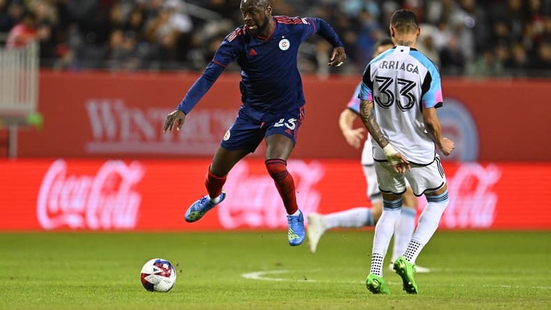 Apr 8, 2023; Chicago, Illinois, USA; Chicago Fire FC forward Kei Kamara (23) leaps past Minnesota United midfielder Kervin Arriaga (33) to gain control of the ball in the first half at Soldier Field. Mandatory Credit: Jamie Sabau-USA TODAY Sports