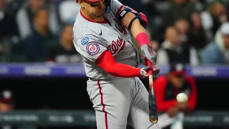 Apr 8, 2023; Denver, Colorado, USA; Washington Nationals first baseman Joey Meneses (45) doubles in the fifth inning against the Colorado Rockies at Coors Field. Mandatory Credit: Ron Chenoy-USA TODAY Sports