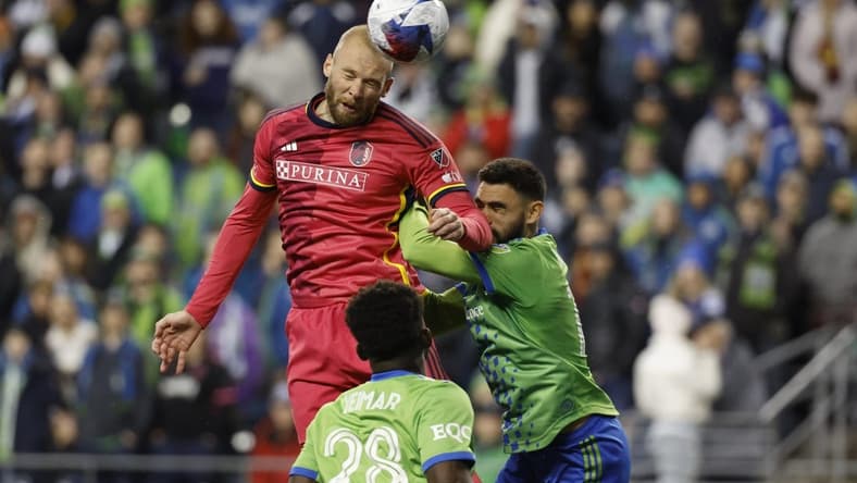 Apr 8, 2023; Seattle, Washington, USA; St. Louis City forward Klauss (9) heads the ball against Seattle Sounders midfielder Joao Paulo (6) during the second half at Lumen Field. Mandatory Credit: Joe Nicholson-USA TODAY Sports