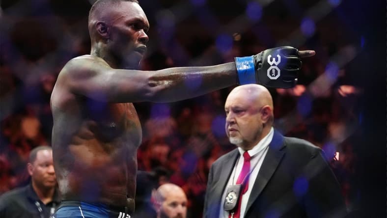 Apr 8, 2023; Miami, Florida, USA; Israel Adesanya (blue gloves) reacts to defeating Alex Pereira (red gloves) during UFC 287 at Miami-Dade Arena. Mandatory Credit: Rich Storry-USA TODAY Sports