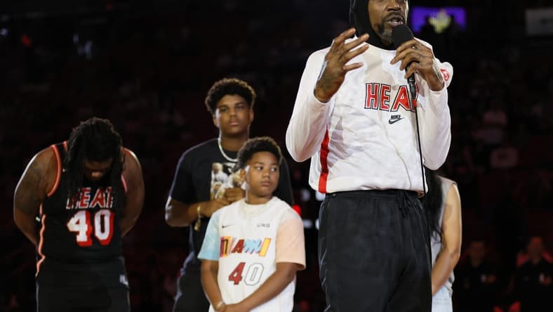 Apr 9, 2023; Miami, Florida, USA; Miami Heat forward Udonis Haslem (40) talks in front of his family during a ceremony to celebrate his last regular season game prior to the game against the Orlando Magic at Kaseya Center. Mandatory Credit: Sam Navarro-USA TODAY Sports