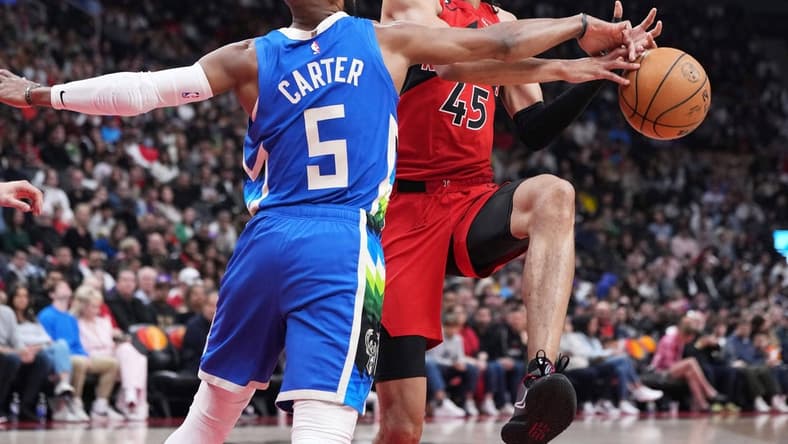 Apr 9, 2023; Toronto, Ontario, CAN;Toronto Raptors guard Dalano Banton (45) controls the ball as Milwaukee Bucks guard Jevon Carter (5) tries to defend during the second quarter at Scotiabank Arena. Mandatory Credit: Nick Turchiaro-USA TODAY Sports