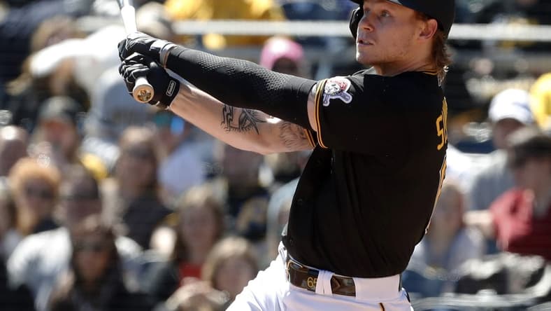Apr 9, 2023; Pittsburgh, Pennsylvania, USA;  Pittsburgh Pirates center fielder Jack Suwinski (65) hits a sacrifice fly RBI against the Chicago White Sox during the second inning at PNC Park. Mandatory Credit: Charles LeClaire-USA TODAY Sports