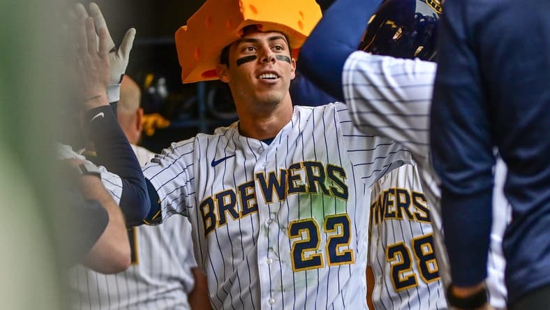 Apr 9, 2023; Milwaukee, Wisconsin, USA; Milwaukee Brewers left fielder Christian Yelich (22) is greeted in the dugout after hitting a solo homer in the seventh inning against the St. Louis Cardinals at American Family Field. Mandatory Credit: Benny Sieu-USA TODAY Sports