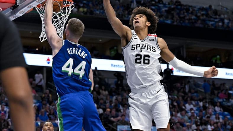 Apr 9, 2023; Dallas, Texas, USA; Dallas Mavericks forward Davis Bertans (44) dunks the ball past San Antonio Spurs forward Dominick Barlow (26) during the second quarter at the American Airlines Center. Mandatory Credit: Jerome Miron-USA TODAY Sports