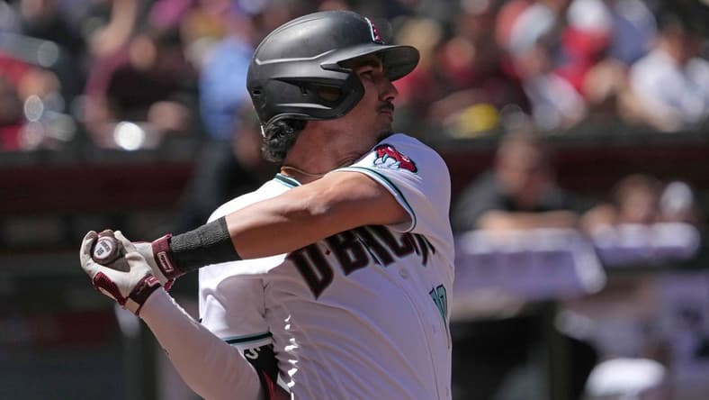 Apr 9, 2023; Phoenix, Arizona, USA; Arizona Diamondbacks third baseman Josh Rojas (10) hits a single against the Los Angeles Dodgers at Chase Field. Mandatory Credit: Joe Camporeale-USA TODAY Sports