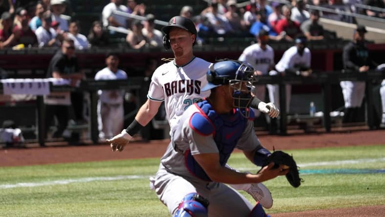 Apr 9, 2023; Phoenix, Arizona, USA; Arizona Diamondbacks designated hitter Pavin Smith (26) beats a throw to Los Angeles Dodgers catcher Austin Barnes (15) to score a run during the first inning at Chase Field. Mandatory Credit: Joe Camporeale-USA TODAY Sports