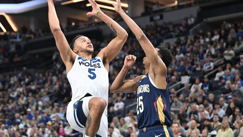 Apr 9, 2023; Minneapolis, Minnesota, USA; Minnesota Timberwolves forward Kyle Anderson (5) goes to the basket as New Orleans Pelicans guard Trey Murphy III (25) defends during the second quarter at Target Center. Mandatory Credit: Jeffrey Becker-USA TODAY Sports