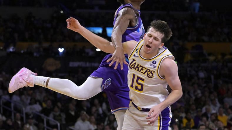 Apr 9, 2023; Los Angeles, California, USA;  Los Angeles Lakers guard Austin Reaves (15) is fouled by Utah Jazz guard Ochai Agbaji (30) as he drives for a basket in the first half at Crypto.com Arena. Mandatory Credit: Jayne Kamin-Oncea-USA TODAY Sports