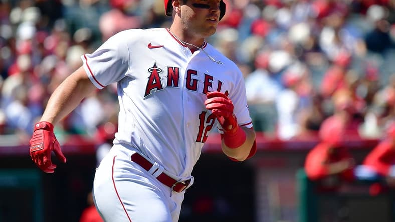 Apr 9, 2023; Anaheim, California, USA; Los Angeles Angels right fielder Hunter Renfroe (12) reaches first on a single against the Toronto Blue Jays during the third inning at Angel Stadium. Mandatory Credit: Gary A. Vasquez-USA TODAY Sports