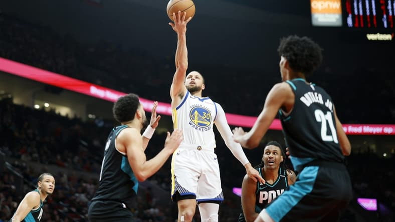 Apr 9, 2023; Portland, Oregon, USA; Golden State Warriors point guard Stephen Curry (30) shoots the ball against Portland Trail Blazers guard Skylar Mays (8, left) and  forward John Butler Jr. (21) during the first half at Moda Center. Mandatory Credit: Soobum Im-USA TODAY Sports