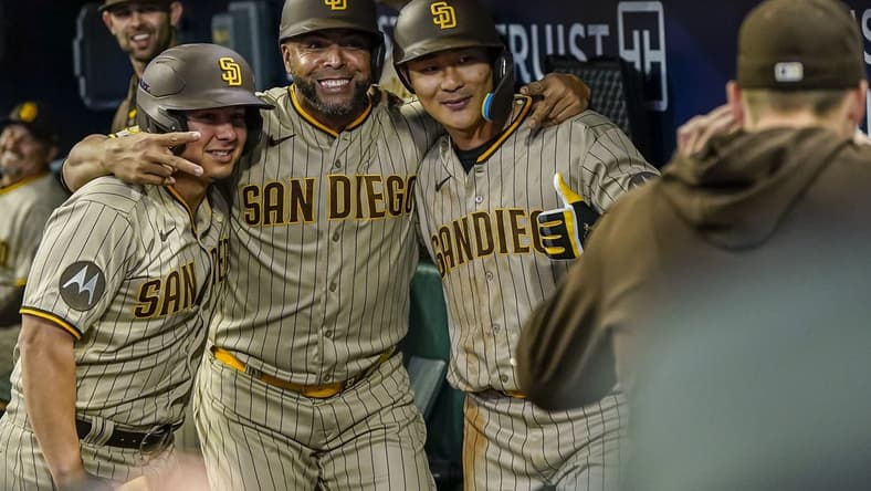 Apr 9, 2023; Cumberland, Georgia, USA; San Diego Padres second baseman Ha-Seong Kim (7) (right) gets a photo in the dugout with designated hitter Nelson Cruz (32) (center) and a bat boy after hitting a home run against the Atlanta Braves during the fifth inning at Truist Park. Mandatory Credit: Dale Zanine-USA TODAY Sports