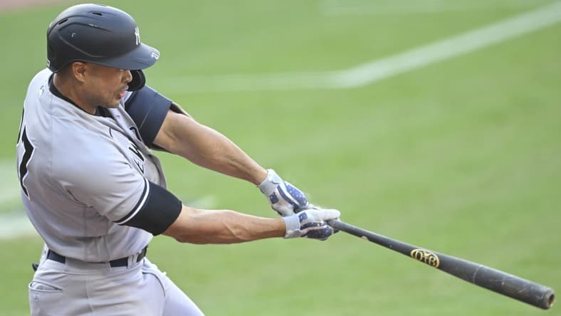 Apr 10, 2023; Cleveland, Ohio, USA; New York Yankees right fielder Giancarlo Stanton (27) hits a two-RBI double in the first inning against the Cleveland Guardians at Progressive Field. Mandatory Credit: David Richard-USA TODAY Sports