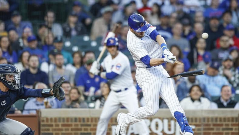 Apr 10, 2023; Chicago, Illinois, USA; Chicago Cubs third baseman Patrick Wisdom (16) breaks his bat as he bats against the Seattle Mariners during the second inning at Wrigley Field. Mandatory Credit: Kamil Krzaczynski-USA TODAY Sports