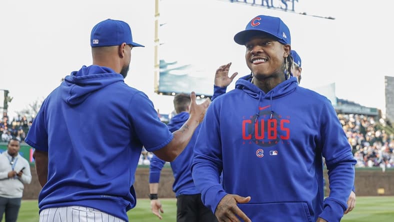 Apr 10, 2023; Chicago, Illinois, USA; Chicago Cubs pitcher Marcus Stroman (R) smiles before a baseball game against the Seattle Mariners at Wrigley Field. Mandatory Credit: Kamil Krzaczynski-USA TODAY Sports