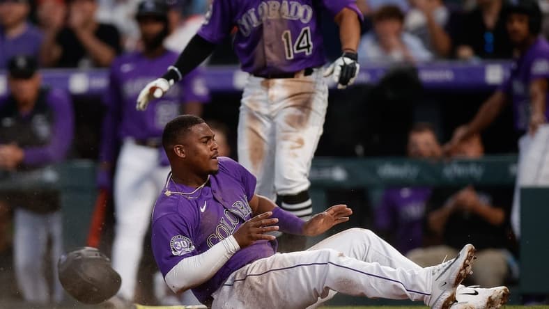 Apr 10, 2023; Denver, Colorado, USA; Colorado Rockies third baseman Elehuris Montero (44) slides into home after being driven in on an RBI in the fourth inning against the St. Louis Cardinals at Coors Field. Mandatory Credit: Isaiah J. Downing-USA TODAY Sports