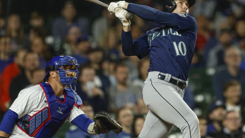 Apr 10, 2023; Chicago, Illinois, USA; Seattle Mariners left fielder Jarred Kelenic (10) hits a solo home run against the Chicago Cubs during the ninth inning at Wrigley Field. Mandatory Credit: Kamil Krzaczynski-USA TODAY Sports